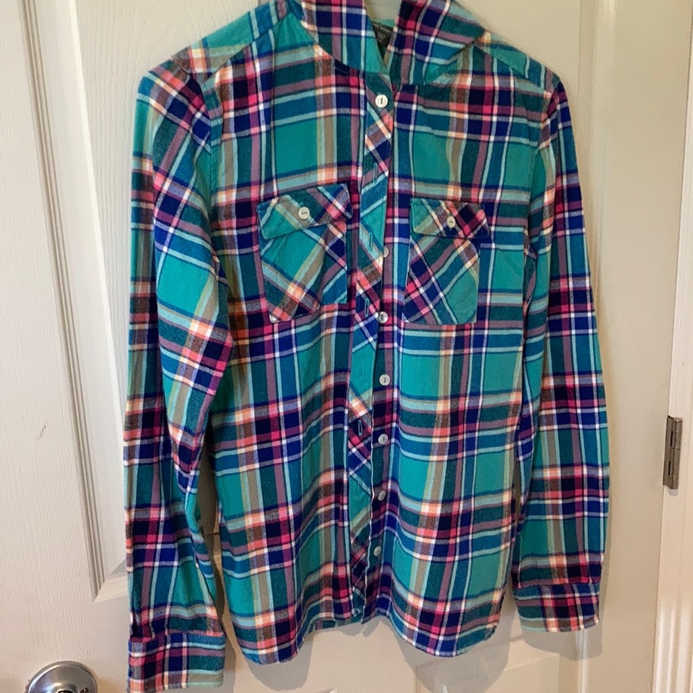 Two button up flannels with hoods and pockets. One blue and a pink.
